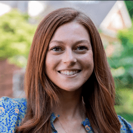 Claire Ansman - lady with long auburn hair with blue paisley shirt